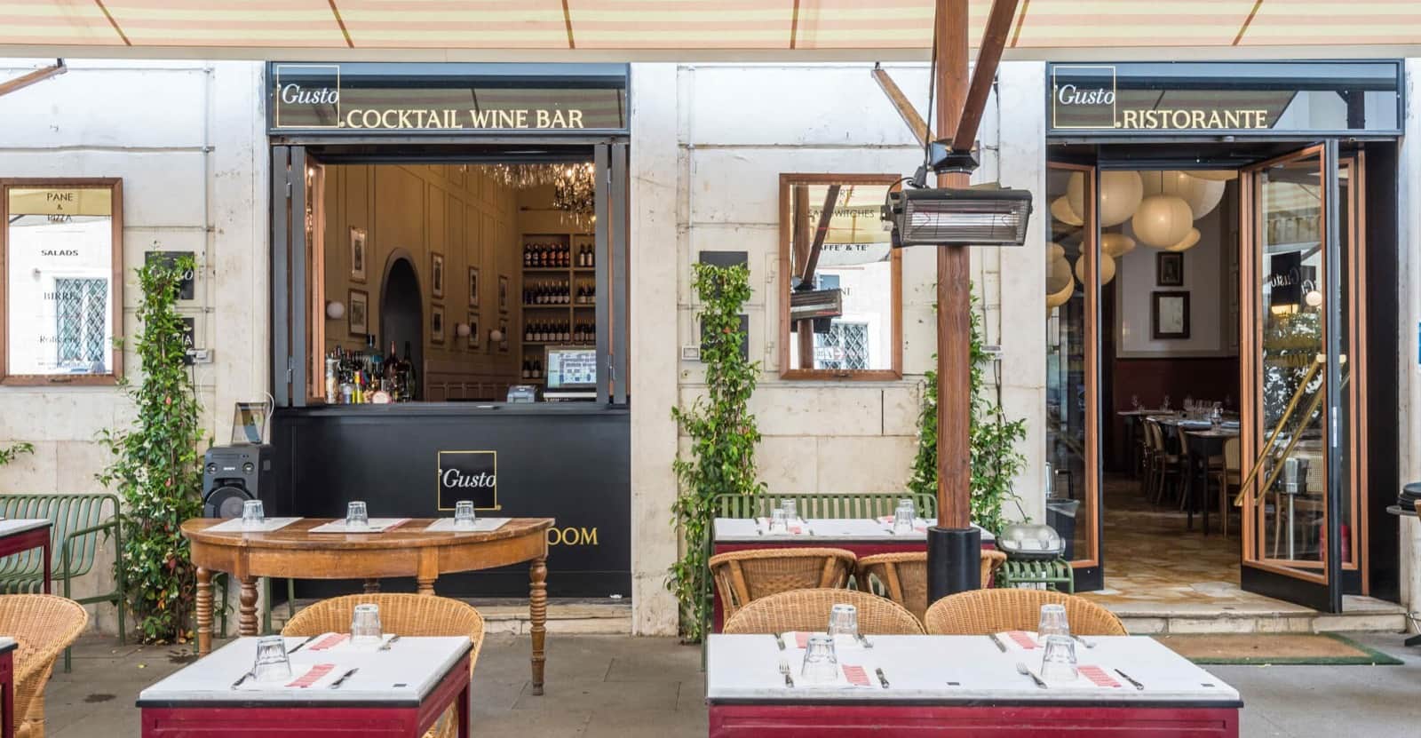 Facciata con due ingressi, insegne 'Cocktail Wine Bar' e 'Ristorante', tavoli apparecchiati all'aperto.
